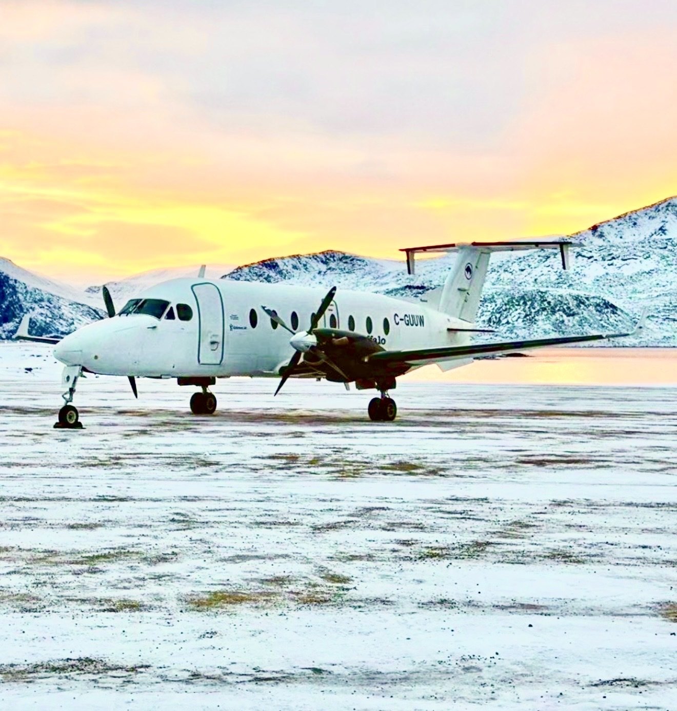 C-GUUW at a mountain strip under a sunrise sky