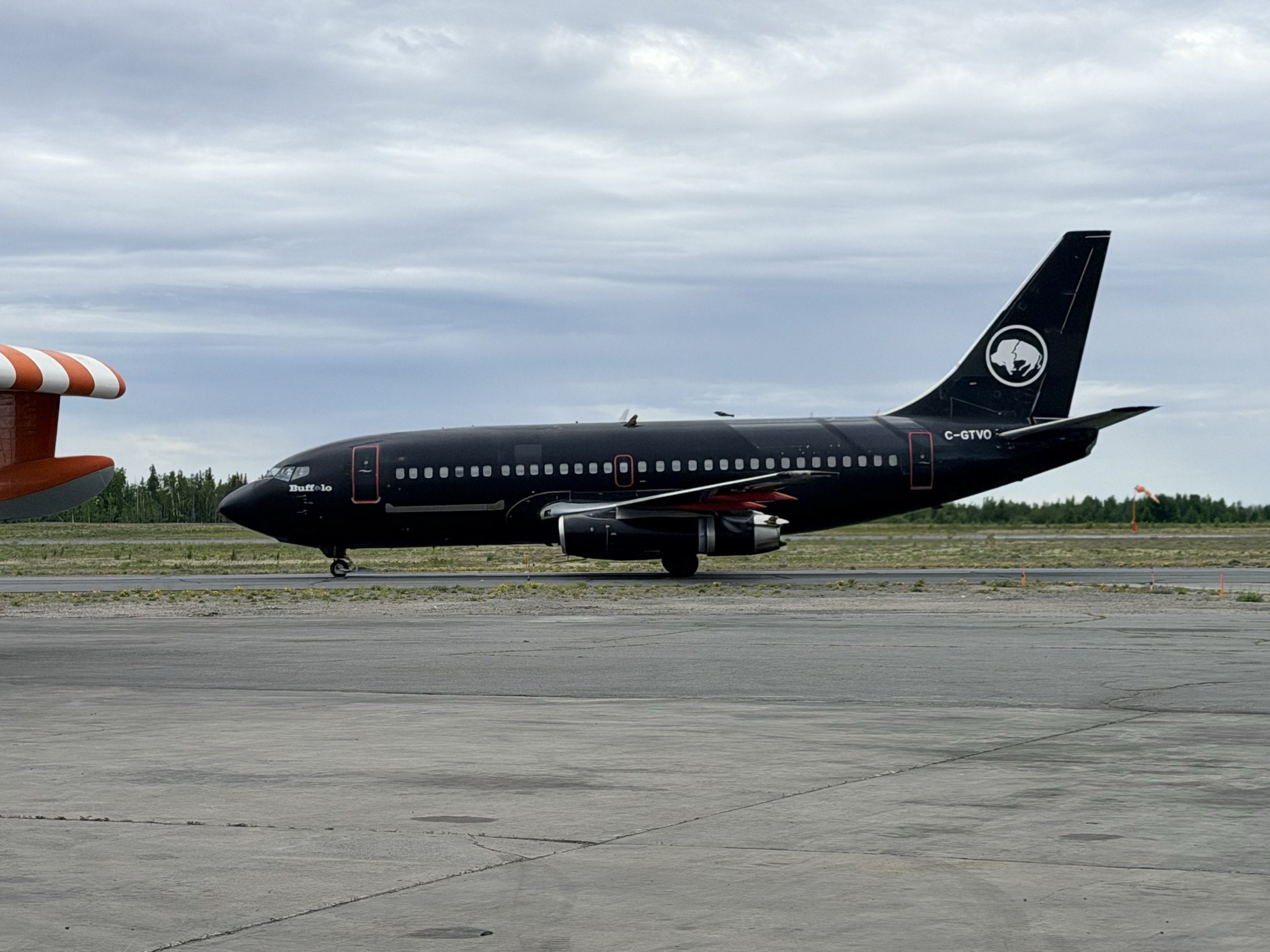C-GTVO full side profile on the taxiway, buffalo roundel on the black tail