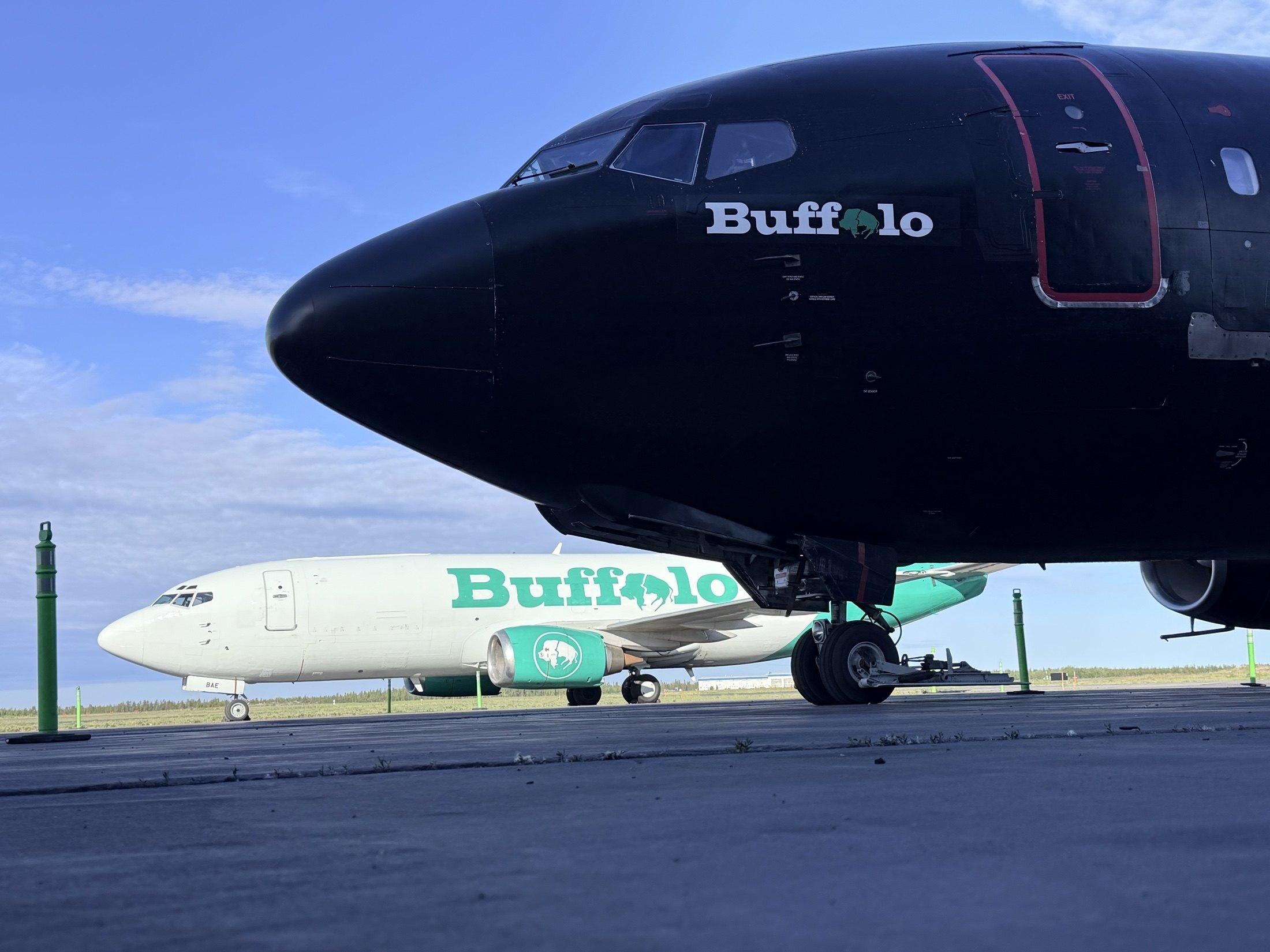 The gravel jet’s black nose in front of C-FBAE — both Buffalo jets in one frame