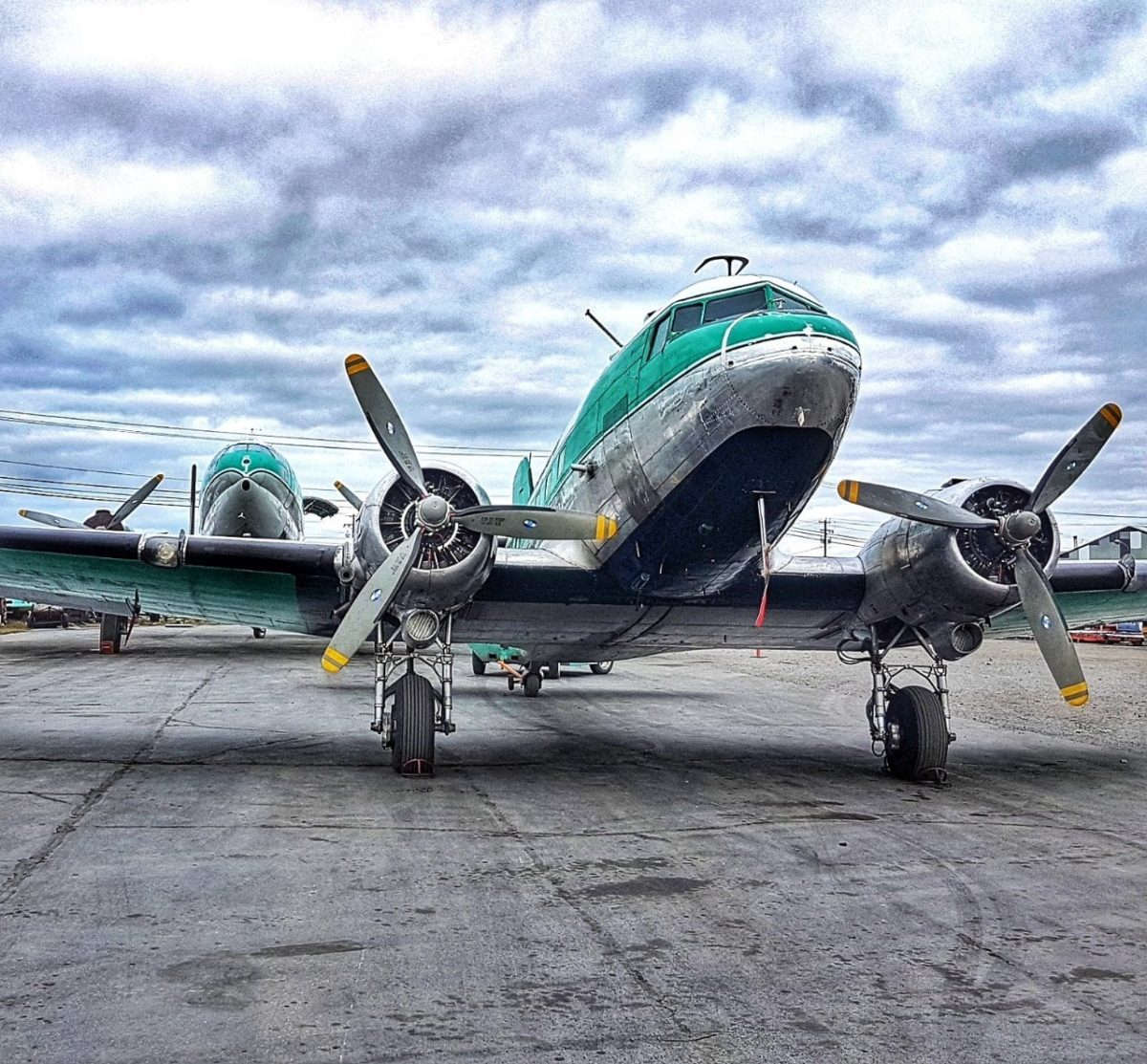 DC-3 front quarter under dramatic cloud