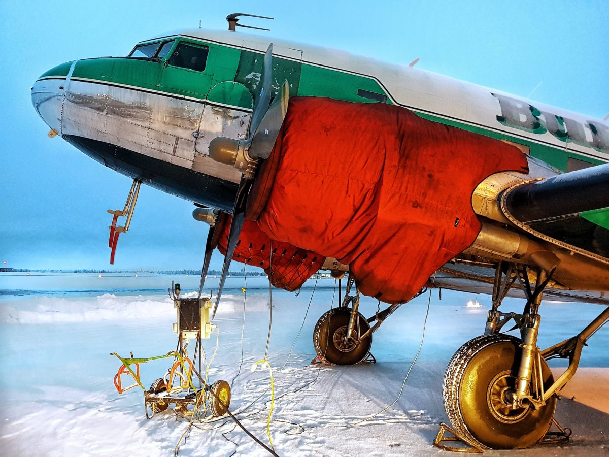 DC-3 under an engine tent on the winter ramp