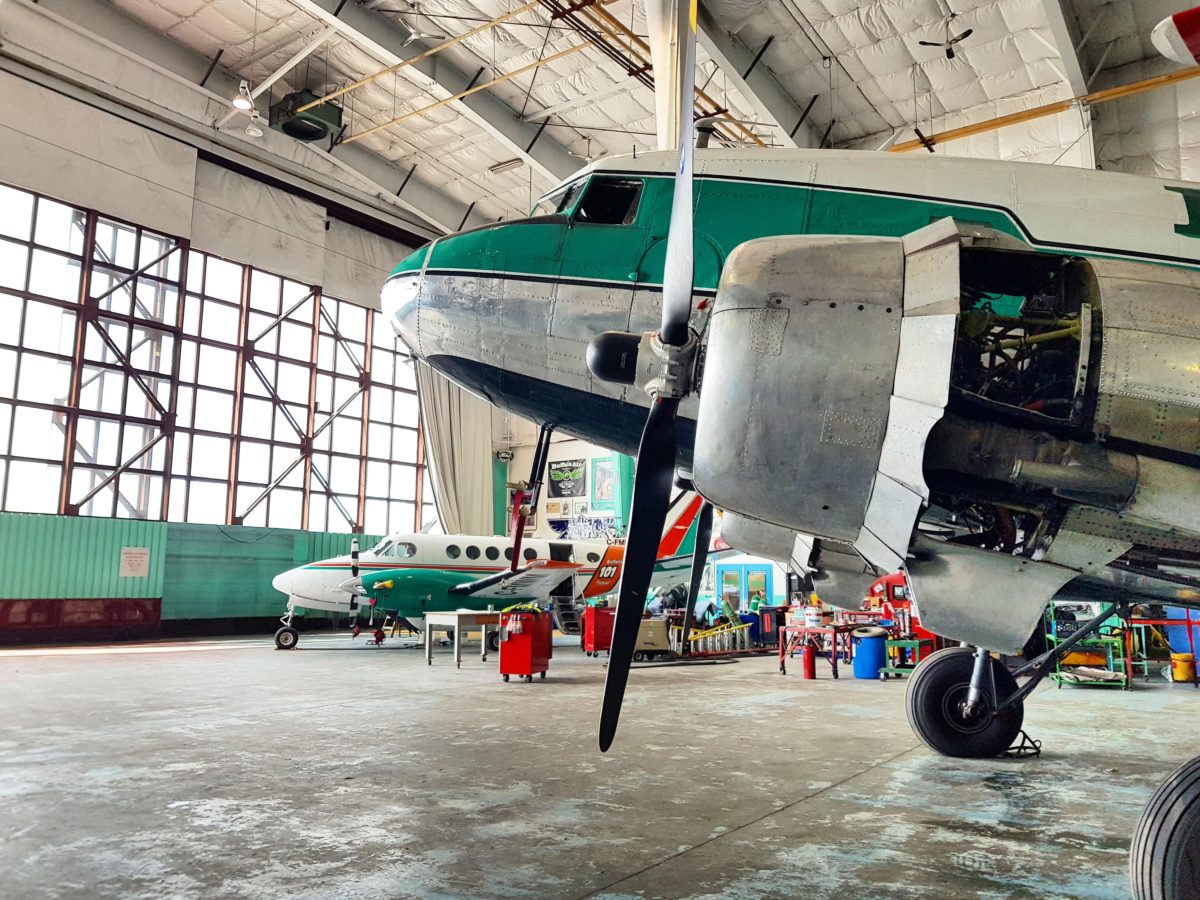 King Air inside the hangar behind a DC-3 propeller