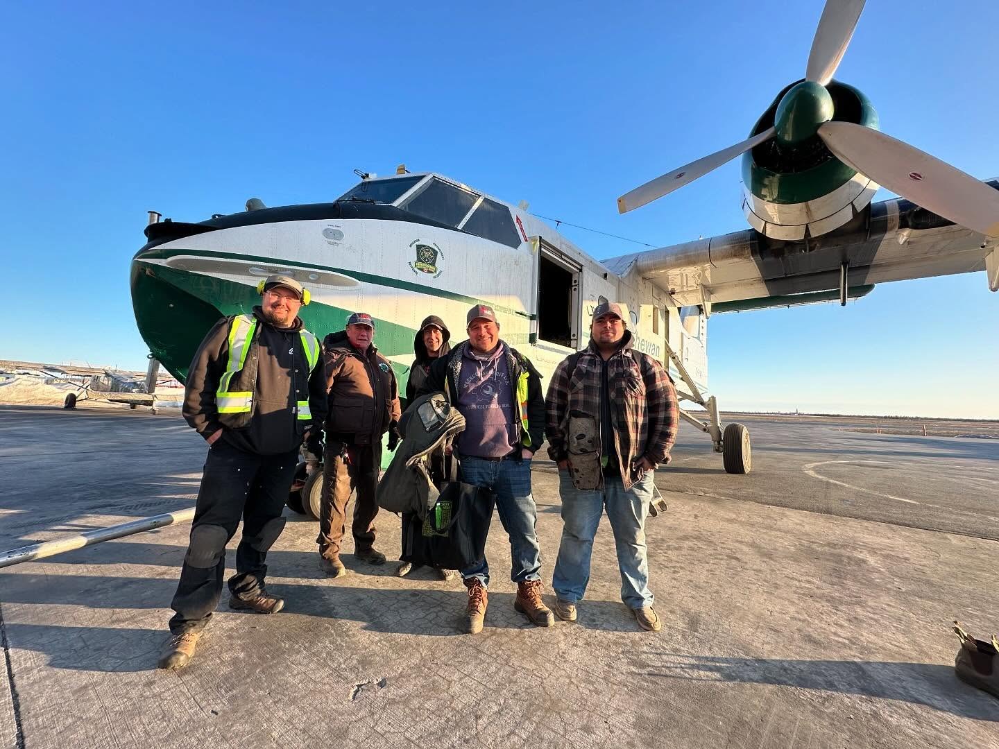 Crew in front of the newly arrived CL-215 C-FYWO in Yellowknife, cargo door open