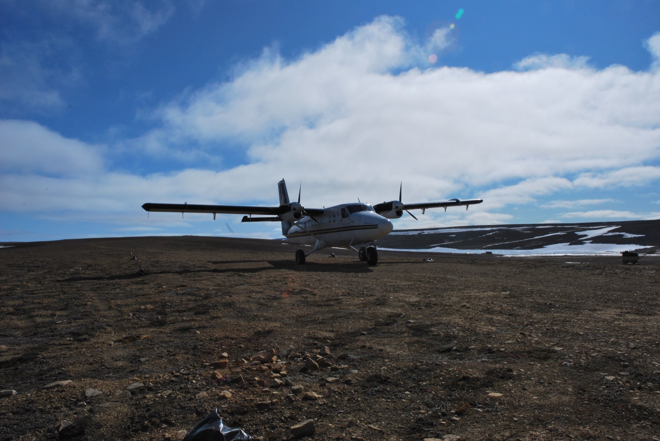 Wide tundra strip, the Twin Otter alone under a big Arctic sky