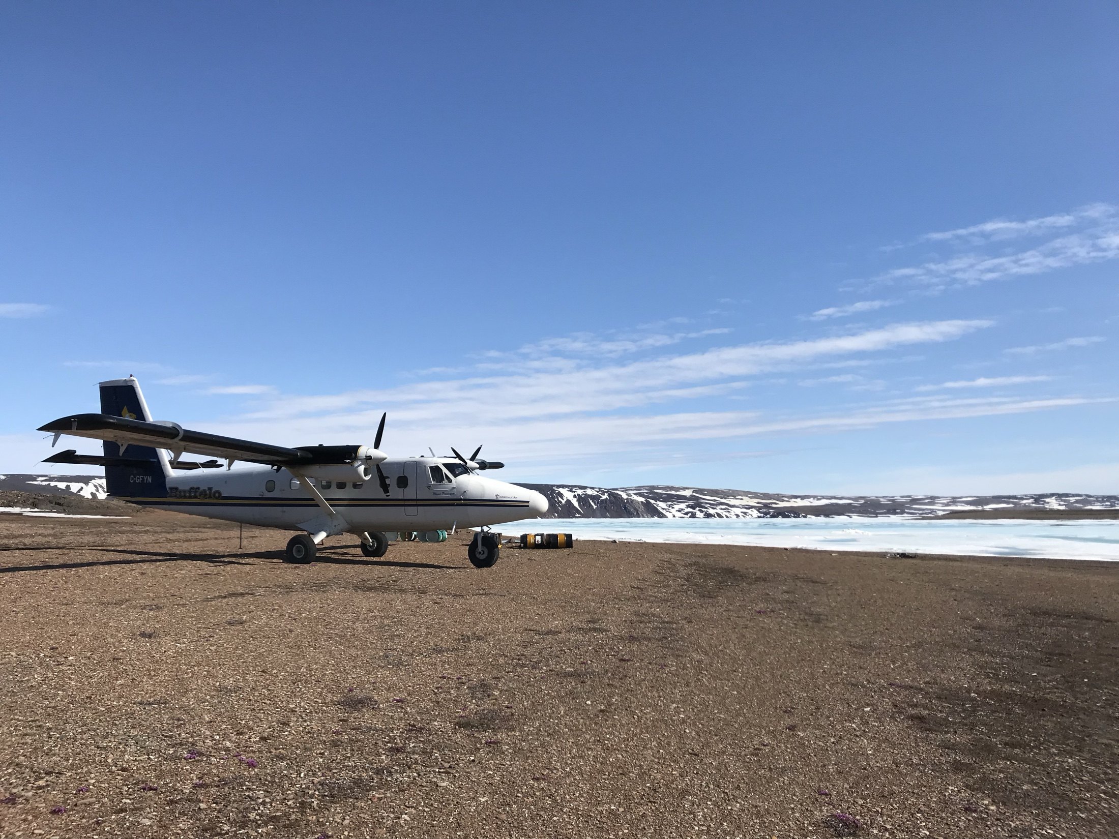 C-GFYN above the shoreline of a frozen Arctic bay